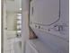 A stackable laundry setup next to the bathroom at 4405 W Fair Oaks Ave # 9, Tampa, FL 33611