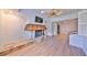 Living room with a stone fireplace, light-colored floors, ceiling fan, and a view of other rooms at 4405 W Fair Oaks Ave # 9, Tampa, FL 33611