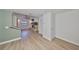Open-concept living area with light wood floors, a view to the stairs, a stone fireplace, and lots of sunlight at 4405 W Fair Oaks Ave # 9, Tampa, FL 33611