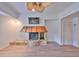 Cozy living room featuring a stone fireplace, light wood floors, a ceiling fan, and neutral wall colors at 4405 W Fair Oaks Ave # 9, Tampa, FL 33611