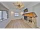 A bright living room featuring a stone fireplace, light-colored flooring, ceiling fan, and bright natural light at 4405 W Fair Oaks Ave # 9, Tampa, FL 33611