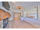 Open-concept living room featuring a stone fireplace and wood-look floors at 4405 W Fair Oaks Ave # 9, Tampa, FL 33611