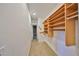 Spacious walk-in closet with wood shelving at 4405 W Fair Oaks Ave # 9, Tampa, FL 33611