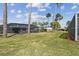 Expansive green backyard with mature trees, including a screened lanai at 4559 Mitcher Rd, New Port Richey, FL 34652