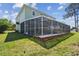 Exterior of home featuring screened lanai and expansive backyard at 4559 Mitcher Rd, New Port Richey, FL 34652