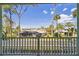 Balcony view showcases lush green landscaping, neighbor homes, and blue skies at 4559 Mitcher Rd, New Port Richey, FL 34652