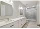 Bathroom with double sink vanity and glass shower at 4559 Mitcher Rd, New Port Richey, FL 34652
