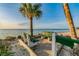 Seaside benches offer a tranquil retreat on a beautiful beach with palm trees and soothing ocean views at 4559 Mitcher Rd, New Port Richey, FL 34652