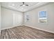 Bright bedroom features wood floors, ceiling fan, and tray ceiling at 4559 Mitcher Rd, New Port Richey, FL 34652