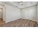Spacious bedroom with a tray ceiling, closet, and wood-look floors at 4559 Mitcher Rd, New Port Richey, FL 34652