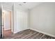 Clean bedroom featuring wood-look floors and a double-door closet for ample storage at 4559 Mitcher Rd, New Port Richey, FL 34652