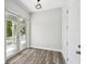 Bedroom with wood floors, a view to the balcony, and recessed lighting at 4559 Mitcher Rd, New Port Richey, FL 34652