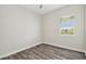 Bright bedroom with wood-look flooring, natural light, and a ceiling fan at 4559 Mitcher Rd, New Port Richey, FL 34652