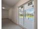 Bonus room featuring neutral paint and flooring with sliding glass door overlooking pool and screened lanai at 4559 Mitcher Rd, New Port Richey, FL 34652