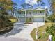 Two-story home featuring a double garage, balconies, and a well-maintained front yard at 4559 Mitcher Rd, New Port Richey, FL 34652