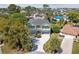 Beautifully landscaped home with balconies, attached garages, a circular driveway, and mature landscaping at 4559 Mitcher Rd, New Port Richey, FL 34652