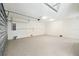 Spacious garage with speckled floor, automatic door, and ample room for storage at 4559 Mitcher Rd, New Port Richey, FL 34652