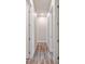 Hallway featuring wood-look floors and doorways leading to other rooms at 4559 Mitcher Rd, New Port Richey, FL 34652
