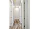 Hallway with hardwood floors, recessed lighting and white trim at 4559 Mitcher Rd, New Port Richey, FL 34652