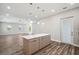 Open floor plan showing kitchen island with seating, seamlessly connecting to the living area at 4559 Mitcher Rd, New Port Richey, FL 34652