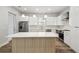 Contemporary kitchen with an island, stainless appliances, and white cabinets offers a clean, modern look at 4559 Mitcher Rd, New Port Richey, FL 34652