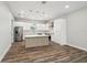 Modern kitchen with white cabinets, center island, and stainless steel appliances at 4559 Mitcher Rd, New Port Richey, FL 34652