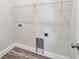Laundry room featuring new floors, washer/dryer hookups, and a shelf for supplies at 4559 Mitcher Rd, New Port Richey, FL 34652
