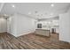 Open-concept living room and kitchen with wood-look flooring and recessed lighting at 4559 Mitcher Rd, New Port Richey, FL 34652
