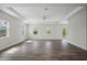 Bright living room with tray ceiling, wood floors, recessed lighting, and multiple windows at 4559 Mitcher Rd, New Port Richey, FL 34652