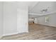 Open living space leads to a modern kitchen, with wood floors and plenty of natural light at 4559 Mitcher Rd, New Port Richey, FL 34652