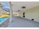 Spacious covered patio with ceiling fans overlooking the pool and landscaped backyard at 4559 Mitcher Rd, New Port Richey, FL 34652