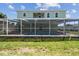 Rear of home featuring a screened in pool and lanai at 4559 Mitcher Rd, New Port Richey, FL 34652