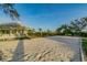 Community recreation area on sand with palm trees and a house in background at 4559 Mitcher Rd, New Port Richey, FL 34652