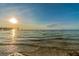 Scenic waterfront view with gentle waves and a distant pier, capturing the essence of coastal living at 4559 Mitcher Rd, New Port Richey, FL 34652