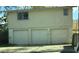 This exterior view shows a multi-car garage, attached to the main house at 4628 Cypress S Way, St Petersburg, FL 33705