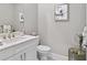 Elegant bathroom featuring a vanity with white cabinets, a toilet, and decorative accents at 4824 Benito Ct, Bradenton, FL 34211