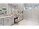 Bright bathroom with double vanity, makeup station, and an expansive shower enclosed with marble tile at 4824 Benito Ct, Bradenton, FL 34211