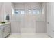 Clean bathroom showcasing a large marble-tiled shower with three arched windows for natural light at 4824 Benito Ct, Bradenton, FL 34211