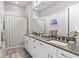 Modern bathroom with double vanity, granite countertops, and decorative shower curtain at 4824 Benito Ct, Bradenton, FL 34211