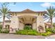 Close up of the clubhouse entrance showcasing architectural details and vibrant landscaping at 4824 Benito Ct, Bradenton, FL 34211