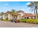 Community clubhouse entrance featuring a covered drive, stone accents, and two golf carts at 4824 Benito Ct, Bradenton, FL 34211