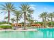Lagoon-style pool with lounge chairs, cabanas, and palm trees, creating a relaxing atmosphere at 4824 Benito Ct, Bradenton, FL 34211