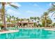 Resort-style pool with lounge chairs, umbrellas, and the Bahama Bar in the background at 4824 Benito Ct, Bradenton, FL 34211