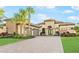 Beautiful home with stone accents, lush landscaping, three-car garage, and arched entry at 4824 Benito Ct, Bradenton, FL 34211