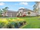 Lush front yard showcases a charming house with a well-manicured lawn and lovely landscaping at 4824 Benito Ct, Bradenton, FL 34211