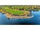 Scenic aerial view of a golf course and lake, showcasing a meticulously maintained landscape at 4824 Benito Ct, Bradenton, FL 34211