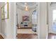 View of home office with chandelier, modern desk, and decor through an open doorway at 4824 Benito Ct, Bradenton, FL 34211