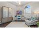 Home office with chandelier, modern desk, decor, and chair with ottoman at 4824 Benito Ct, Bradenton, FL 34211