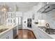 Bright kitchen featuring stainless steel appliances, white cabinets, and a view of the living space at 4824 Benito Ct, Bradenton, FL 34211