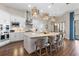 Well-lit kitchen with white cabinetry, stainless steel appliances, an island, and a view to the outside patio at 4824 Benito Ct, Bradenton, FL 34211